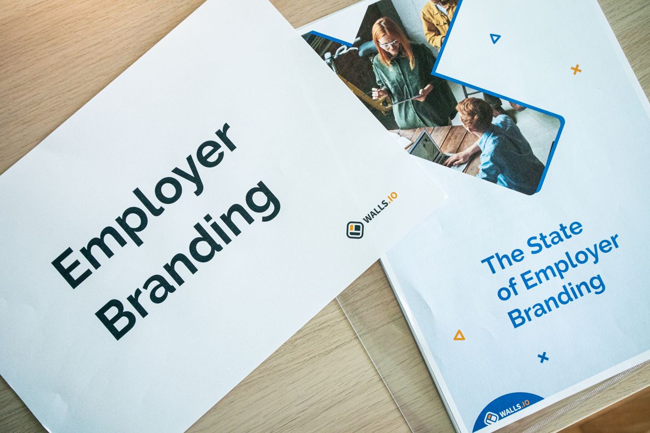 Services Flat lay of employer branding materials on an office table, showcasing marketing and design.