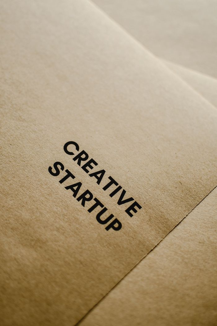 Services A close-up image of black text 'Creative Startup' on brown paper, highlighting entrepreneurship and innovation.